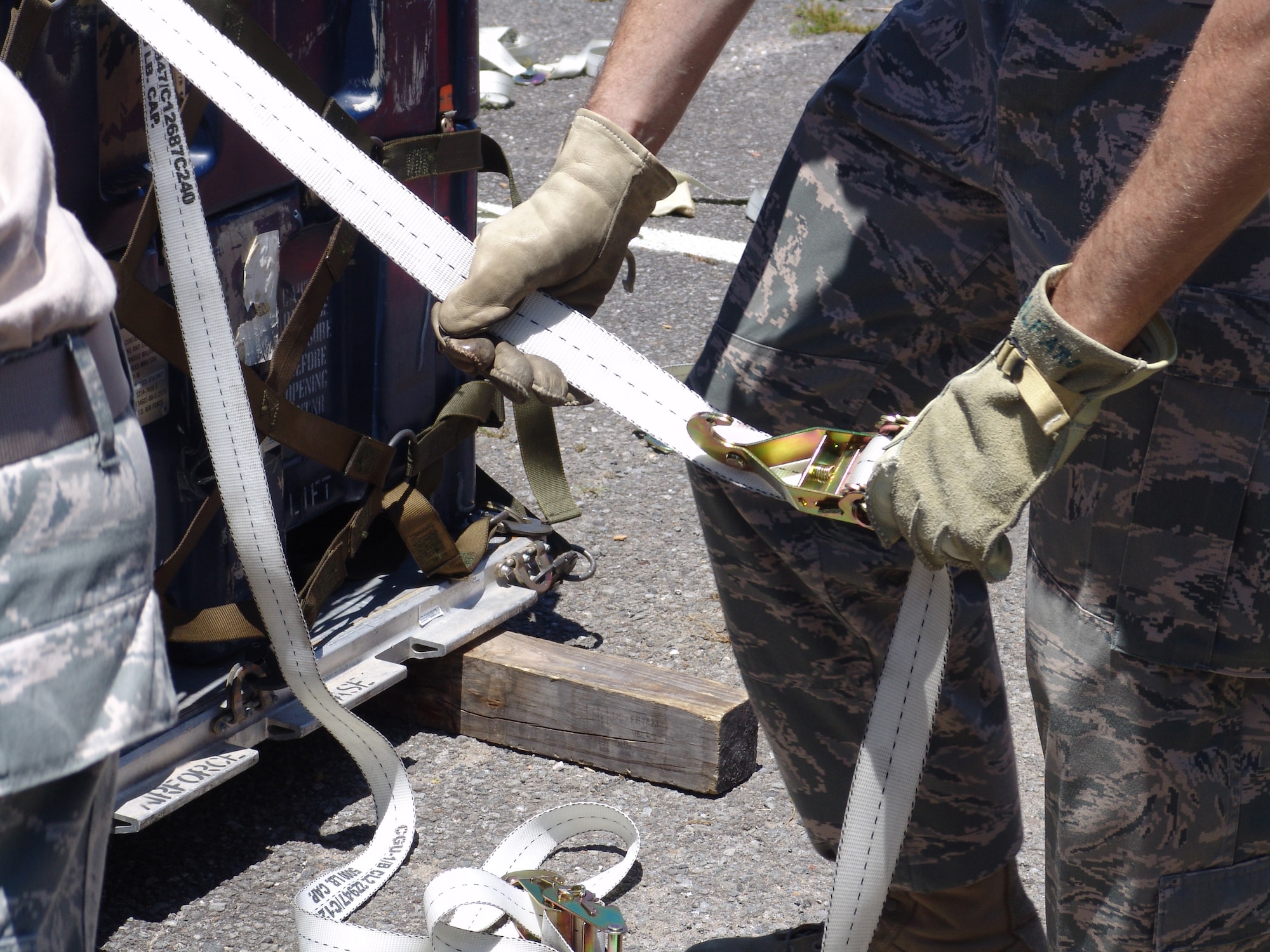 Pulling the straps tight is a key component in building a pallet which was one of the tasks during the 96th Logistics Readiness Squadron's ROADEO June 11. (USAF photo/Lois Walsh)