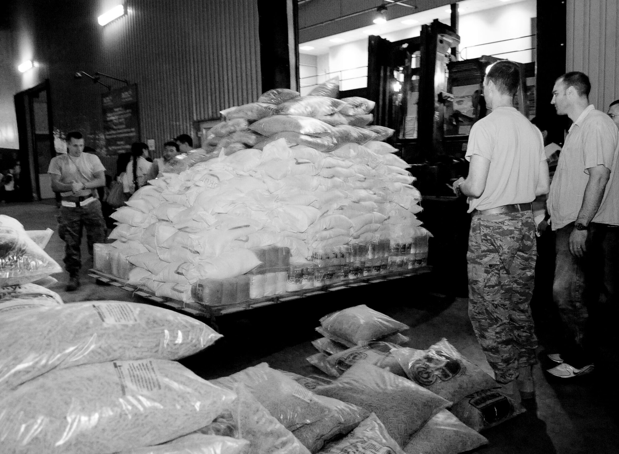 Transit Center at Manas Airmen load 31,000 pounds of food onto a pallet at the Manas International Airport for transportation to Osh, Kyrgyzstan, June 13, 2010. The Transit Center, together with the U.S. Department of State, purchased food and other basics totaling more than 31,000 pounds for a humanitarian assistance delivery to the southern region of Osh.  (U.S. Air Force photo/ Senior Airman Nichelle Anderson/ released)