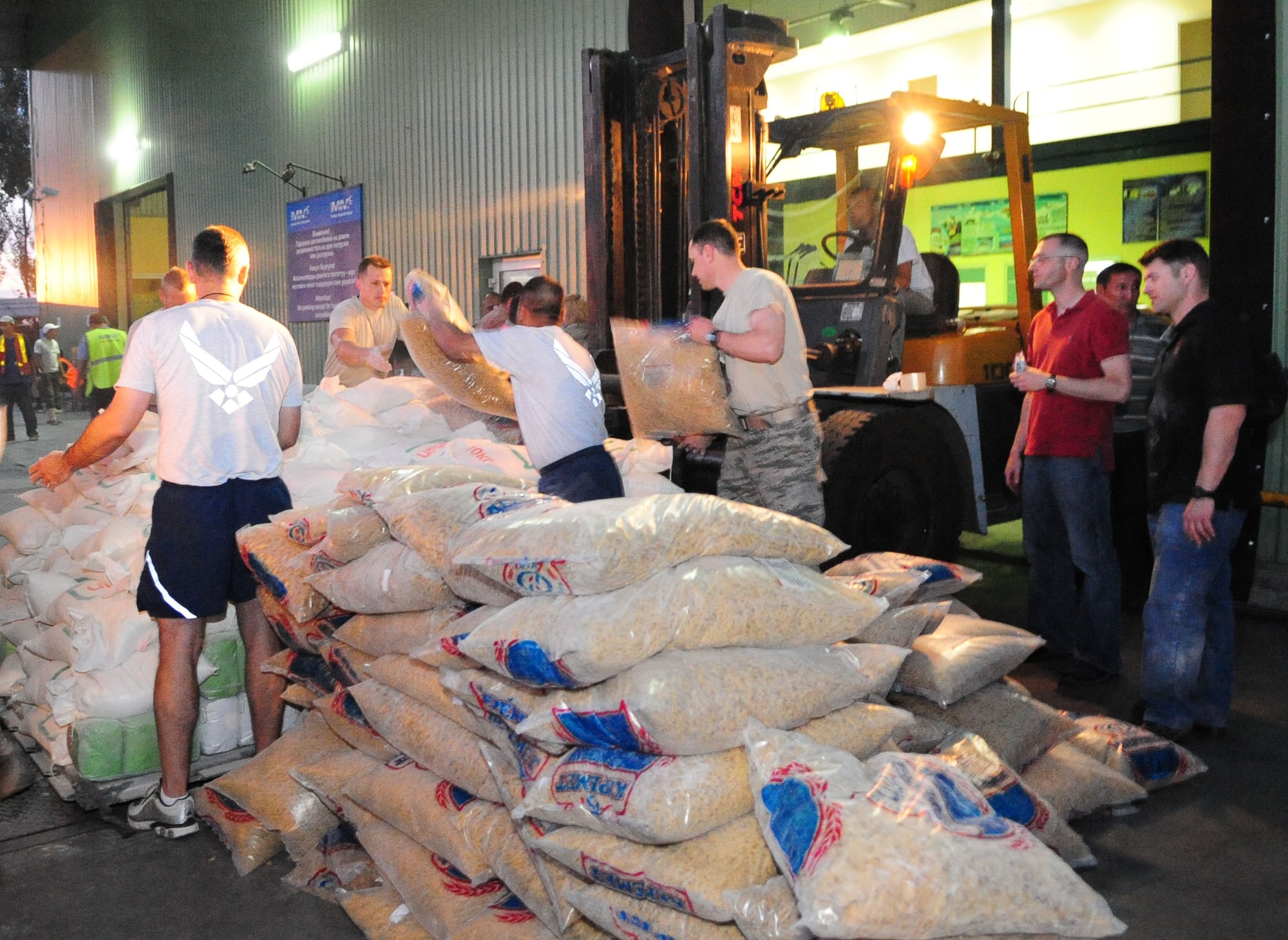 Transit Center at Manas Airmen load 31,000 pounds of food onto a pallet at the Manas International Airport for transportation to Osh, Kyrgyzstan, June 13, 2010. The Transit Center, together with the U.S. Department of State, purchased food, fuel, and water totaling more than 31,000 pounds for a humanitarian assistance delivery to the southern region of Osh.  (U.S. Air Force photo/ Senior Airman Nichelle Anderson/ released)