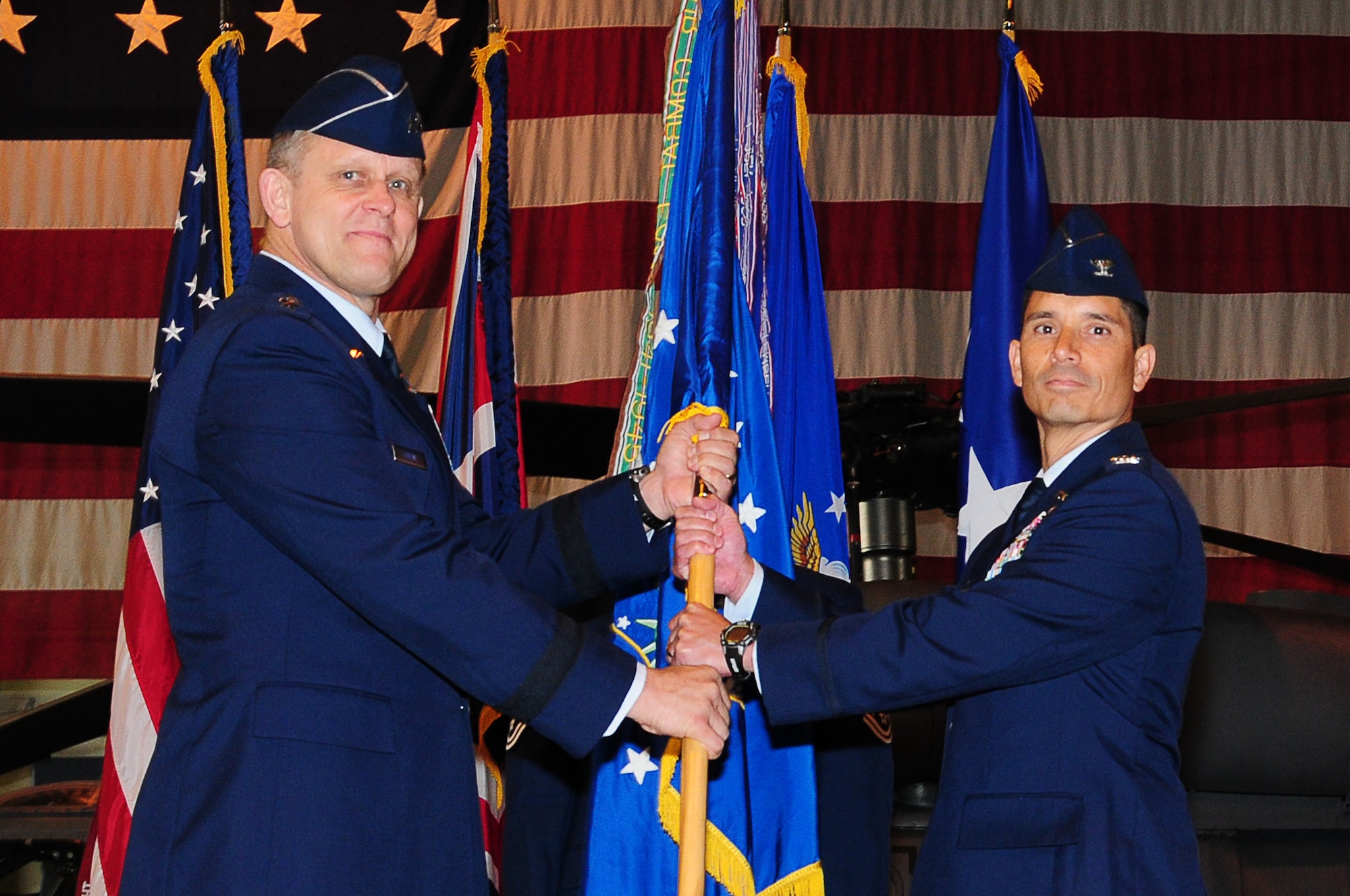 Col. John Quintas receives the 48th Fighter Wing guidon from Lt. Gen. Frank Gorenc, 3rd Air Force commander, during a change of command ceremony at Hangar 7 June 14. Colonel Quintas assumed command of the 48 FW after serving as commander of the 48th Operations Group for the past two years. (U.S. Air Force photo/Airman 1st Class Lausanne Morgan)