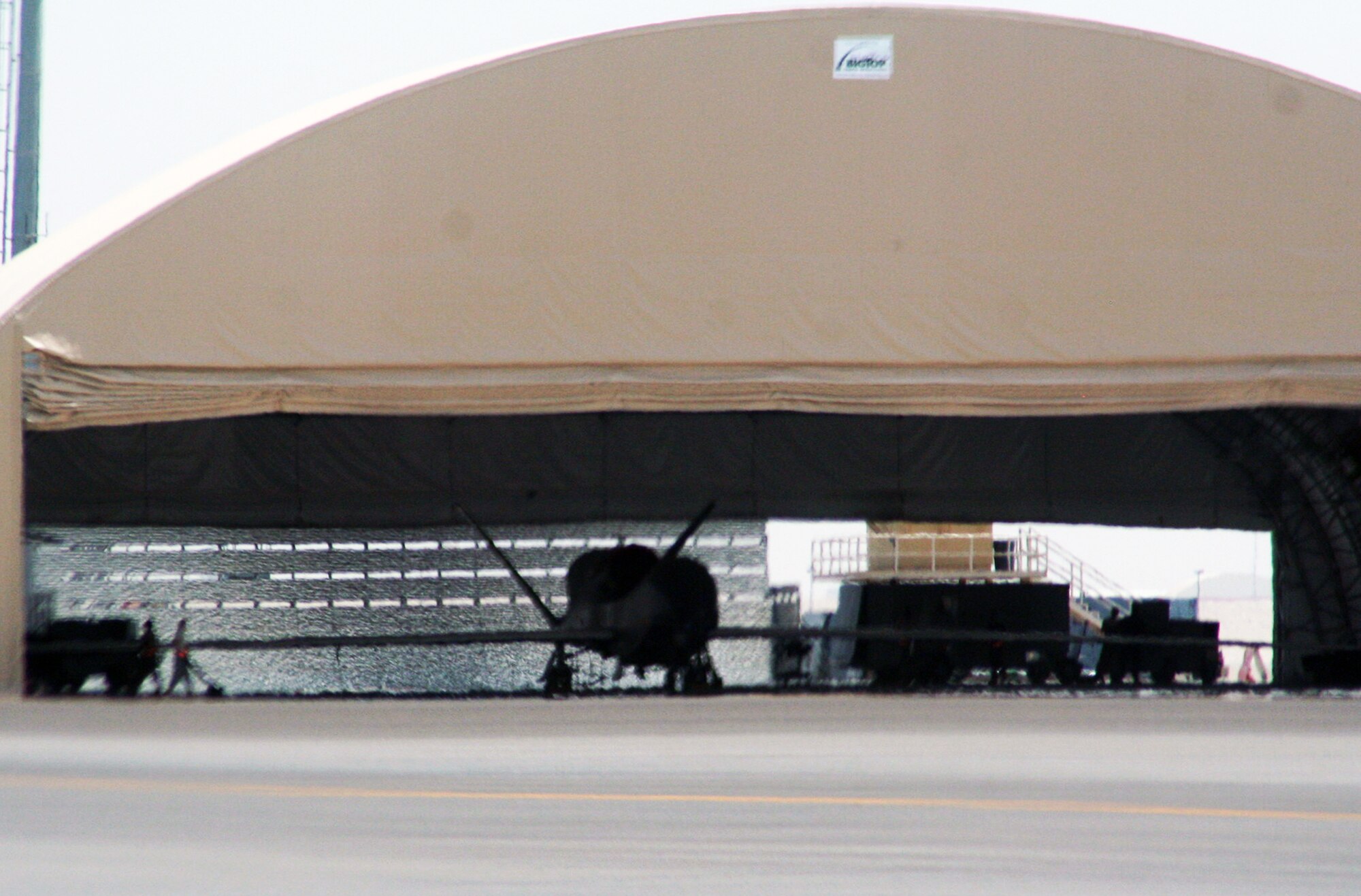 Maintenance Airmen from the 380th Expeditionary Aircraft Maintenance Squadron Hawk aircraft maintenance unit work on an RQ-4 Global Hawk during operations for the 380th Air Expeditionary Wing at a non-disclosed base in Southwest Asia on May 19, 2010. The RQ-4 is one of four airframes assigned to the 380th AEW which supports operations Iraqi Freedom, Enduring Freedom and the Combined Joint Task Force-Horn of Africa. (U.S. Air Force Photo/Master Sgt. Scott T. Sturkol/Released)