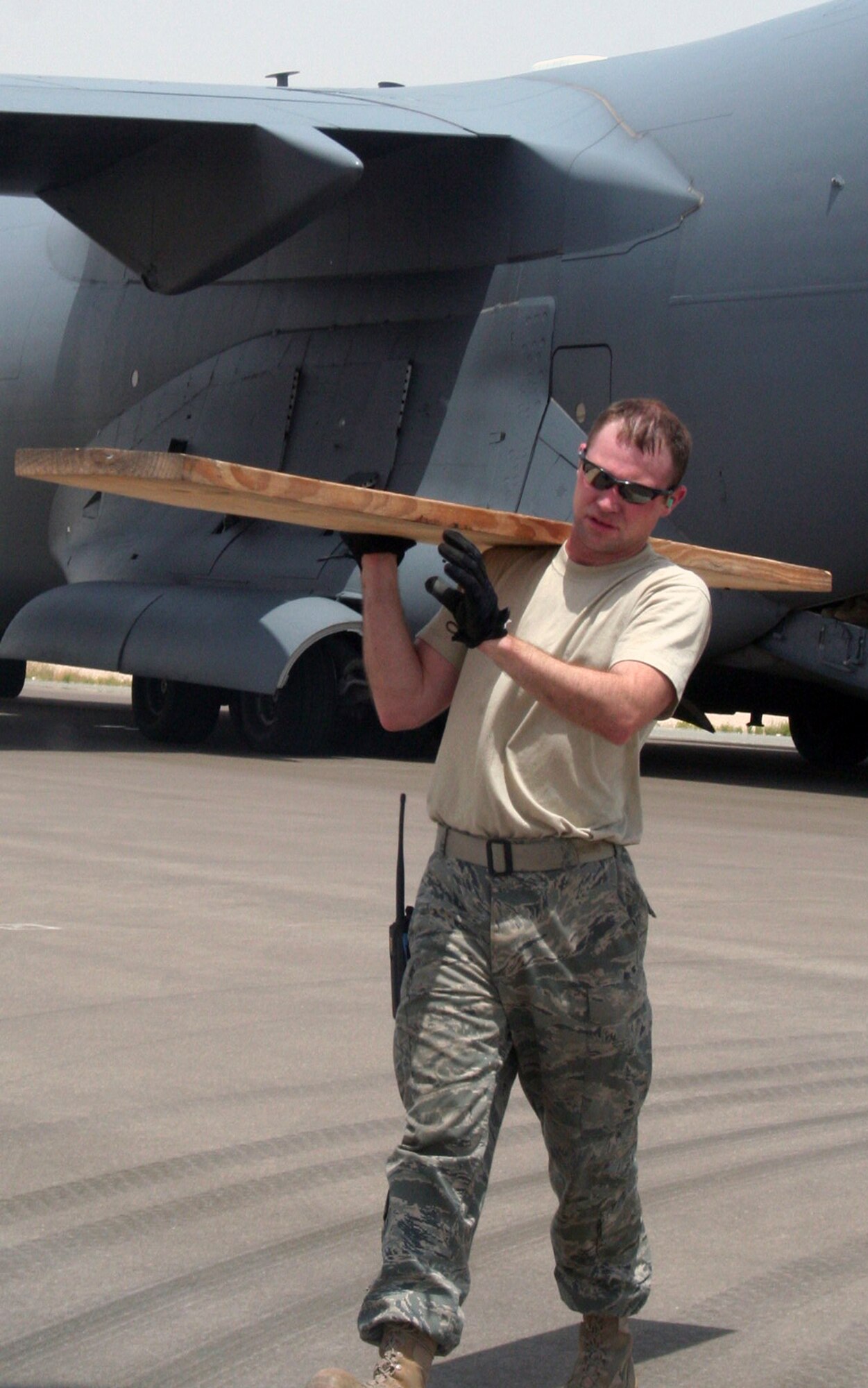 Staff Sgt. Ryan Powers and other air transportation Airmen from the 380th Expeditionary Logistics Readiness Squadron's Air Terminal Operations Center work on the flightline during operations for the 380th Air Expeditionary Wing at a non-disclosed base in Southwest Asia on  May 19, 2010. The 380th AEW supports operations Iraqi Freedom and Enduring Freedom and the Combined Joint Task Force-Horn of Africa. All air transportation Airmen deployed with the 380th AEW are deployed from the 89th Aerial Port Squadron at Joint Base Andrews, Md. Sergeant Belnavis' hometown is Jamestown, Ohio. (U.S. Air Force Photo/Master Sgt. Scott T. Sturkol/Released)