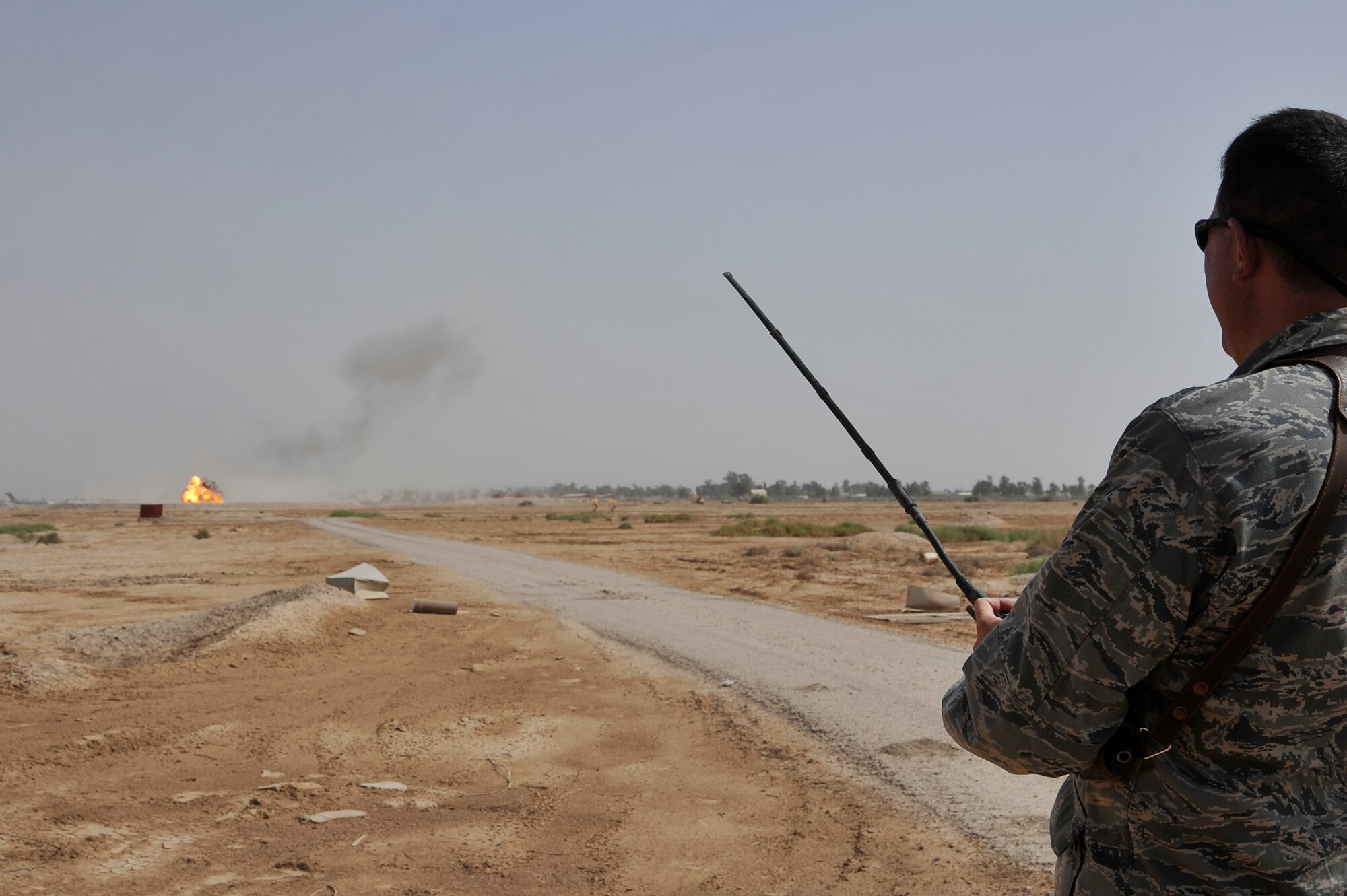 Lt. Col. Jeffry Rice, 447th Air Expeditionary Group, Deputy Commander, pushes a detonating device while assisting EOD technicians during a controlled detonation, June 12, 2010 at Sather Air Base, Iraq. EOD performs two controlled detonations a week, destroying hazardous unexploded ordinance, unserviceable munitions, and ammo from the amnesty boxes located on base. (U.S. Air Force photo by Senior Airman Perry Aston) (Released)
