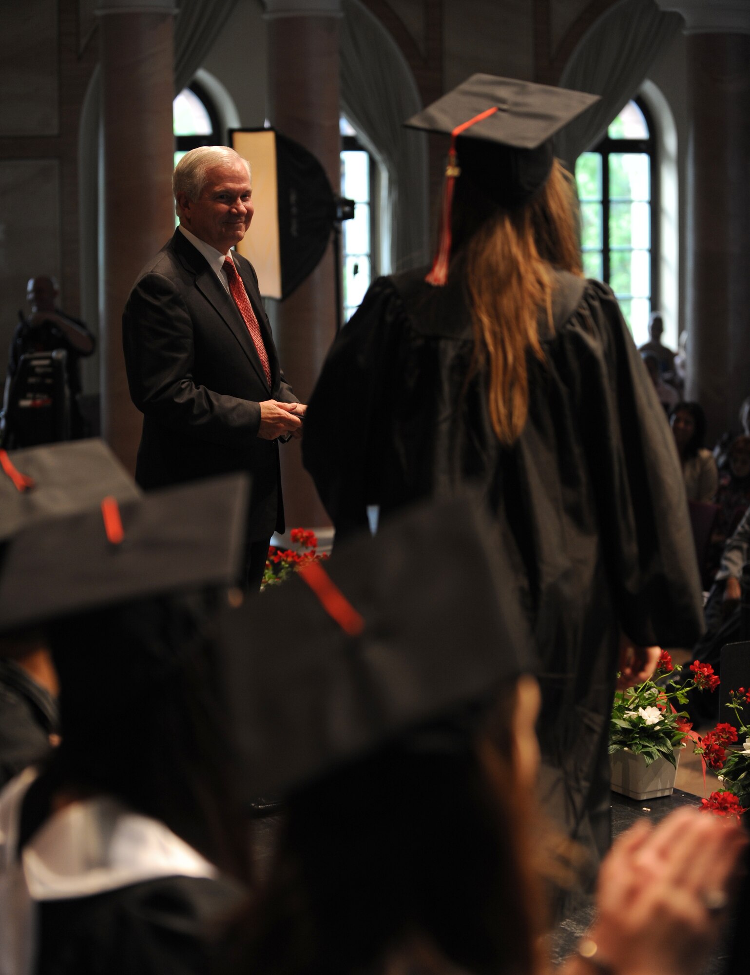 Secretary of Defense Robert M. Gates presents graduates their diplomas at the Kaiserslautern High School graduation ceremony Kaiserslautern, Germany, June 11, 2010.  Secretary Gates accepted the student body's invitation to be the commencement speaker, honoring the many graduates that are also military dependents. (U.S. Air Force photo by Airman 1st Class Caleb Pierce)