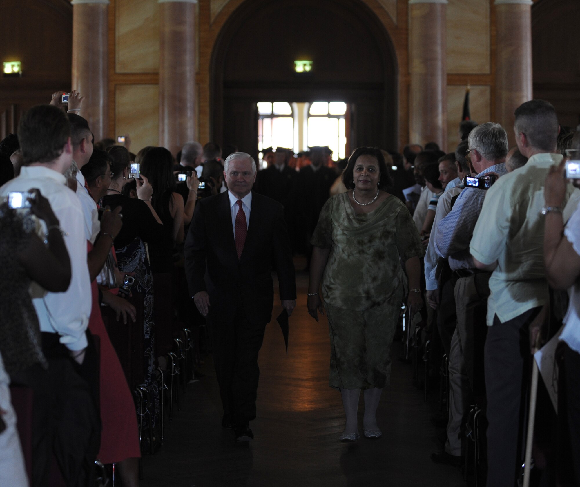 Secretary of Defense Robert M. Gates and Dr. Jennifer Beckwith, Kaiserslautern High School principle, are welcomed by attendees at the KHS graduation ceremony, Kaiserslautern, Germany, June 11, 2010.  Secretary Gates accepted the student body's invitation to be the commencement speaker, honoring the many graduates that are also military dependents. (U.S. Air Force photo by Airman 1st Class Caleb Pierce)