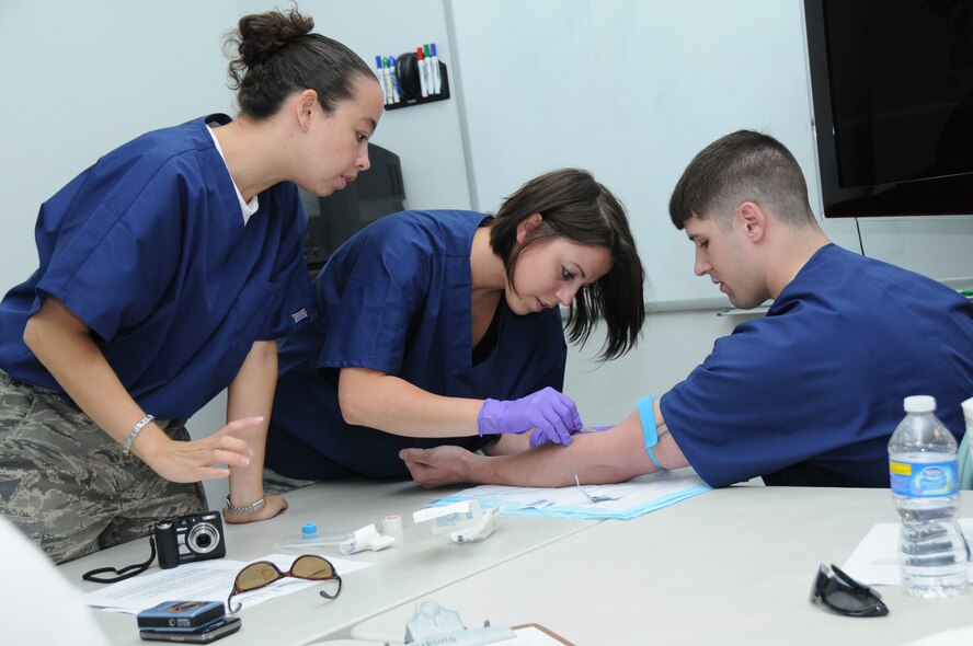 Master Sgt. Kim Hulse, Airman 1st Class April Loeper and Staff Sgt. Matthew Nettles participate in intravenous (IV) training at the Keaau Clinic in Keaau, Hawaii.  Hulse, Loeper and Nettles are medical techs with 193rd Special Operations Wing's Medical Group out of Middletown, Pa. The 193rd Medical Group are in Hilo Hawaii to preform Medical Innovative Readiness Training.