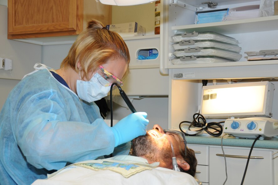 Senior Airman Kim Coolbaugh, cleans the teeth of Ryan Nases, a Hilo Hawaii resident, at Keaau Clinic in Keaau, Hawaii. Coolbaugh is a dental assistant with the 193rd Special Operations Wing's Medical Group out of Middletown, Pa, who are in Hilo Hawaii to preform Medical Innovative Readiness Training.