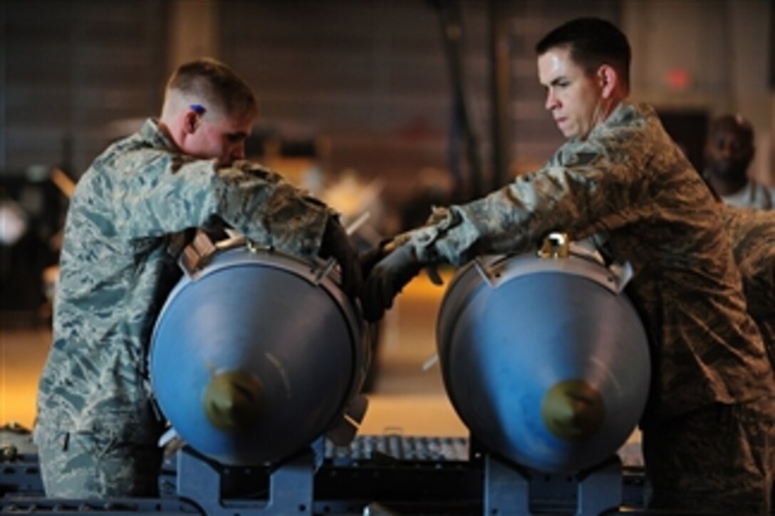 U.S. Air Force Senior Airman Joshua Price (left) and Staff Sgt. Darrell Rinde, both from the 28th Munitions Squadron, build two training bombs during the Global Strike Challenge at Ellsworth Air Force Base, S.D., on June 9, 2010.  The 28th Bomb Wing is one of seven bomb wings participating in the Air Force Global Strike Command?s first load competition.  
