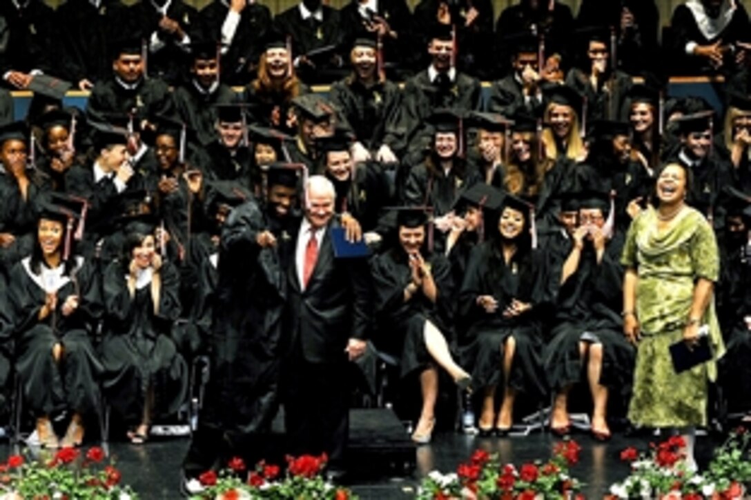 U.S. Defense Secretary Robert M. Gates receives a hug from a graduate during Kaiserslautern High School's commencement at the Fruchthalle in Kaiserslautern, Germany, June 11, 2010.
