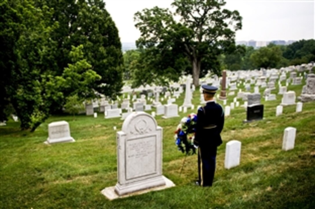 A soldier with The Old Guard, 3rd U.S. Infantry Regiment, stands by the gravesite of former Army Chief of Staff Maj. Gen. Hugh Lenox Scott on the Army's 235th birthday in Arlington National Cemetery, Va., June 14, 2010.