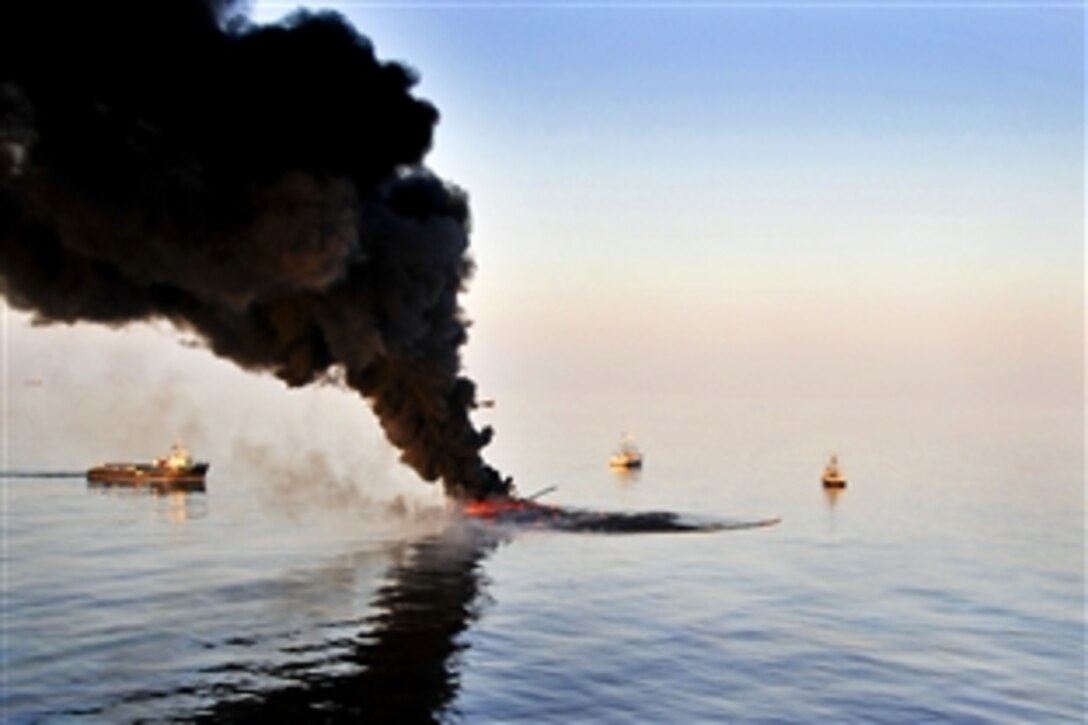 Vessels conduct controlled burns as part of a coordinated federal, state and local effort to minimize the amount of oil in the water near the BP Deepwater Horizon oil spill site in the Gulf of Mexico, June 13, 2010. More than 165 controlled burns have been conducted, removing more than 3.85 million gallons of oil.
