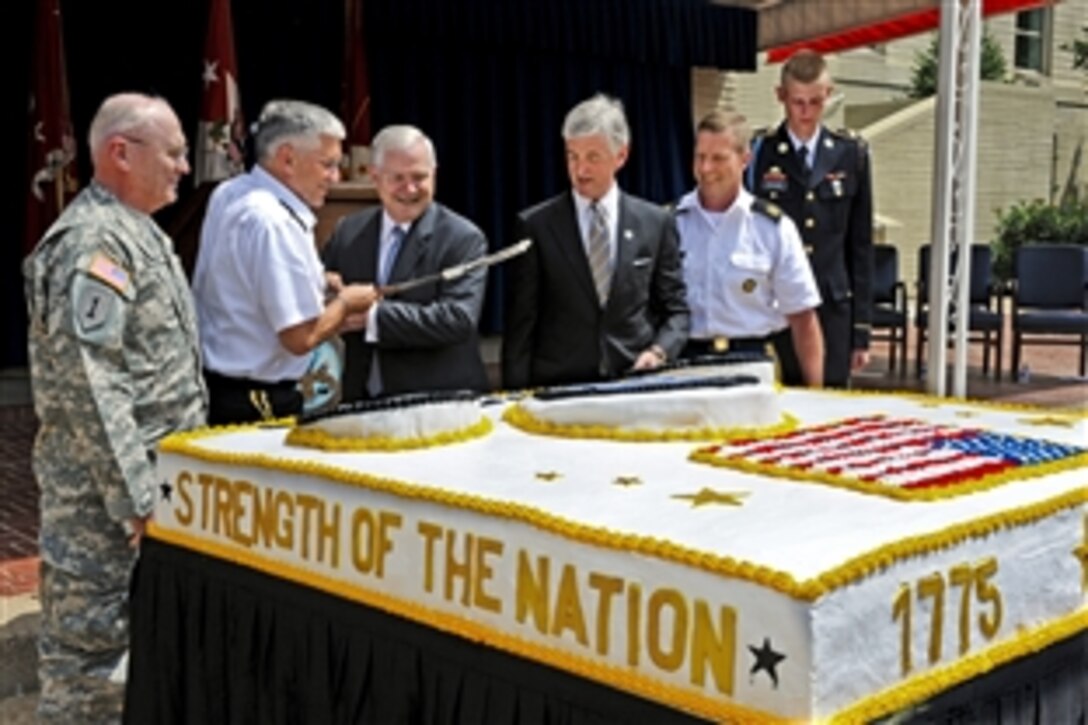 Army Chief of Staff Gen. George W. Casey, second from left, Defense Secretary Robert M. Gates, center, Army Secretary John M. McHugh and Sgt. Maj. of the Army Kenneth O. Preston use a sword to cut the cake for the Army's 235th birthday ceremony at the Pentagon, June 14, 2010.