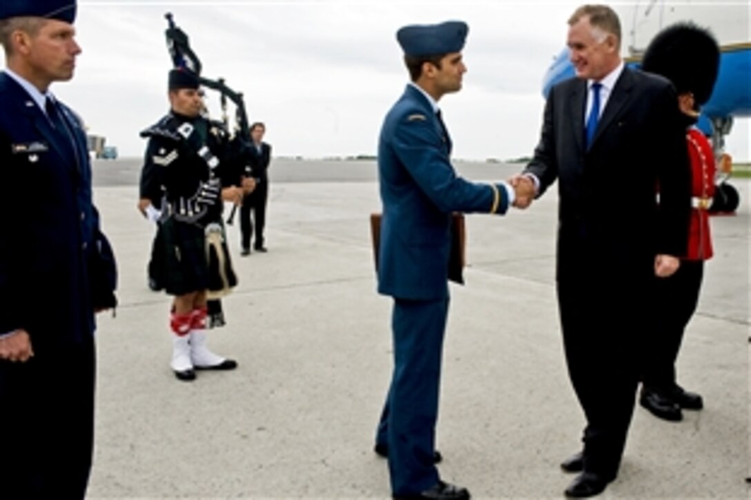 Canadian 2nd Lt. Alexi Quellet, protocol officer, greets Deputy Defense Secretary William J. Lynn III upon his arrival in Ottawa, June 14, 2010.