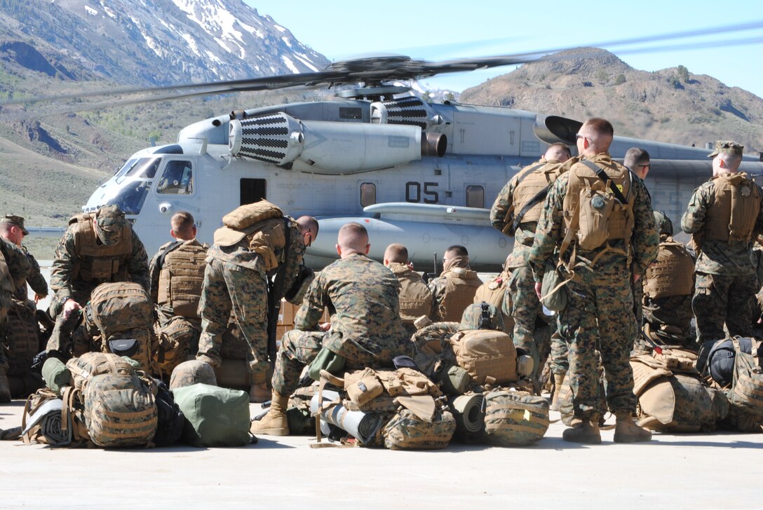 Marines from Company B, 1st Battalion, 25th Marine Regiment, prepare gear, in preparation for departure on a CH-53, in support of Operation Javelin Thrust.