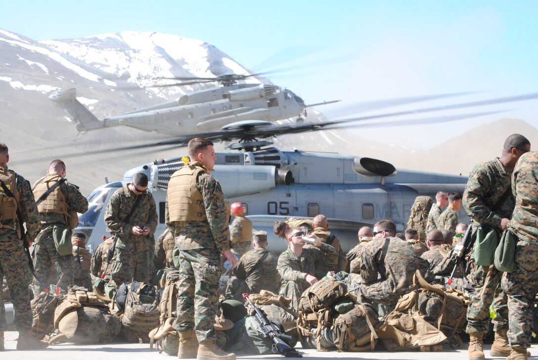 Marines from Company B, 1st Battalion, 25th Marine Regiment, prepare gear, in preparation for departure on a CH-53, in support of Operation Javelin Thrust.