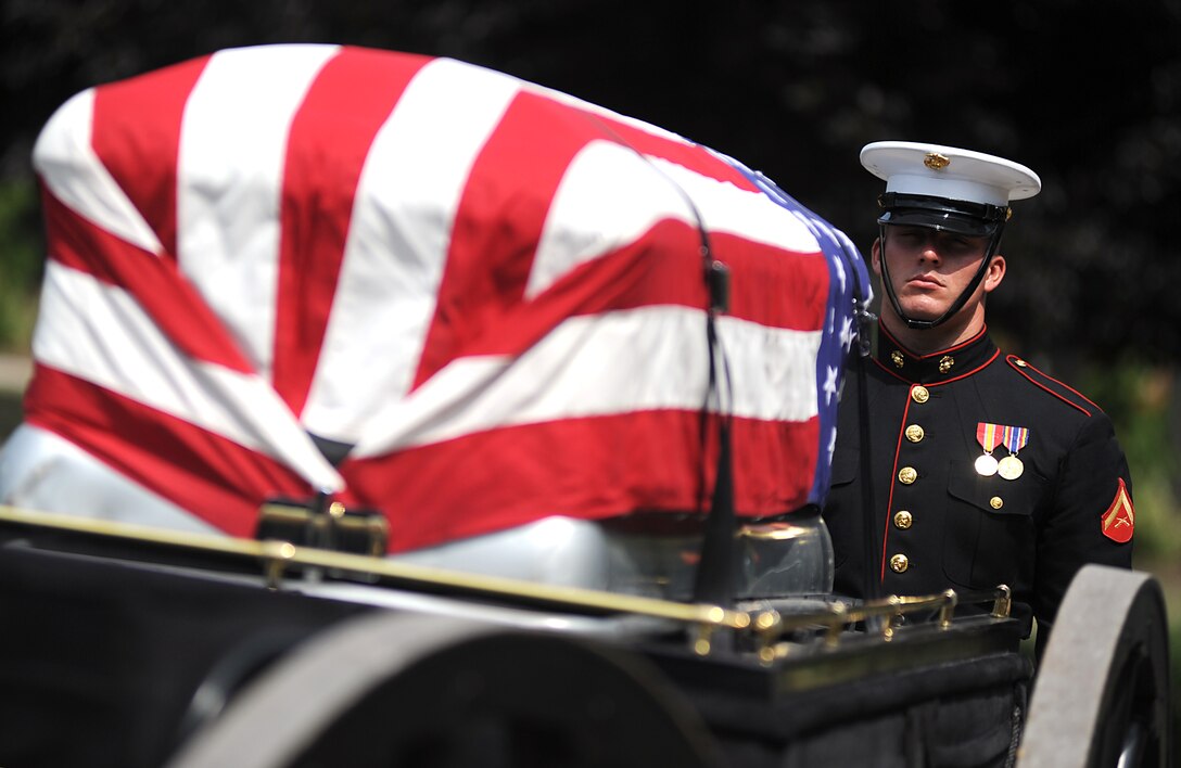 Lance Cpl. Jonathan Lindsey walks behind the casket of retired Col. John S. Hudson during a funeral ceremony at Arlington National Cemetery June 14. Lindsey is a Marine Corps body bearer stationed at Marine Barracks Washington. Body bearers are responsible for carrying the remains of fallen Marines to their final resting place. (Photo by Cpl. Bobby J. Yarbrough)