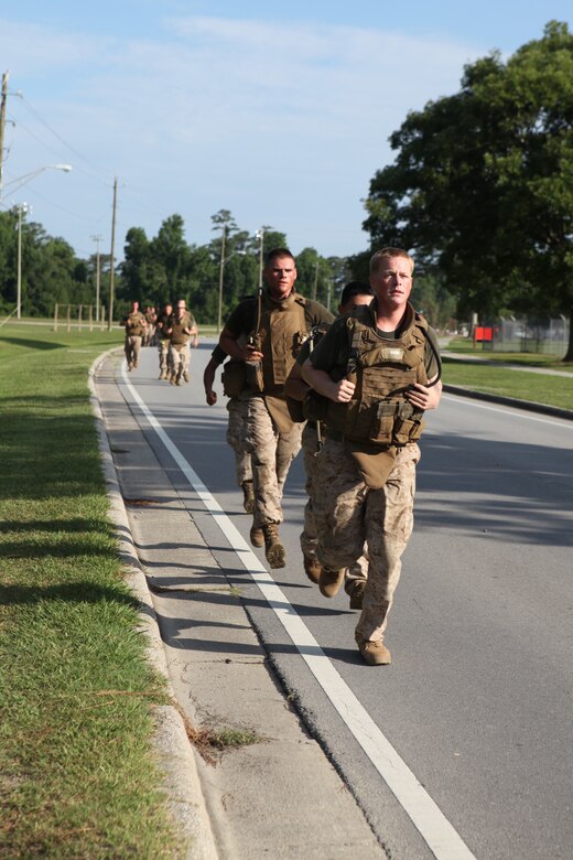 Marines with second platoon, Company L, 3rd Battalion, 2nd Marine Regiment, 2nd Marine Division, run down Julian C. Smith Road aboard Marine Corps Base Camp Lejeune in their modular tactical vests, June 15.  Julian C. Smith Road, from Cross Street to O Street, is closed from 6:00 to 8:00 a.m., Mondays through Fridays, to give Marines and sailors a safe area to conduct unit or individual physical training.