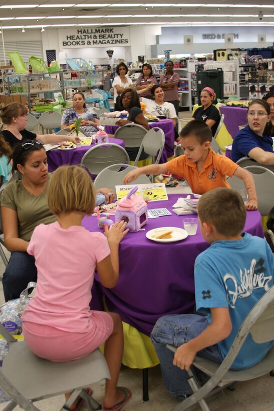 Mothers and their children enjoy refreshments during the Mothers-to-Bee social at the Marine Corps Exchange June 15. The social presented expectant and new mothers with information about services and benefits they can apply.::r::::n::