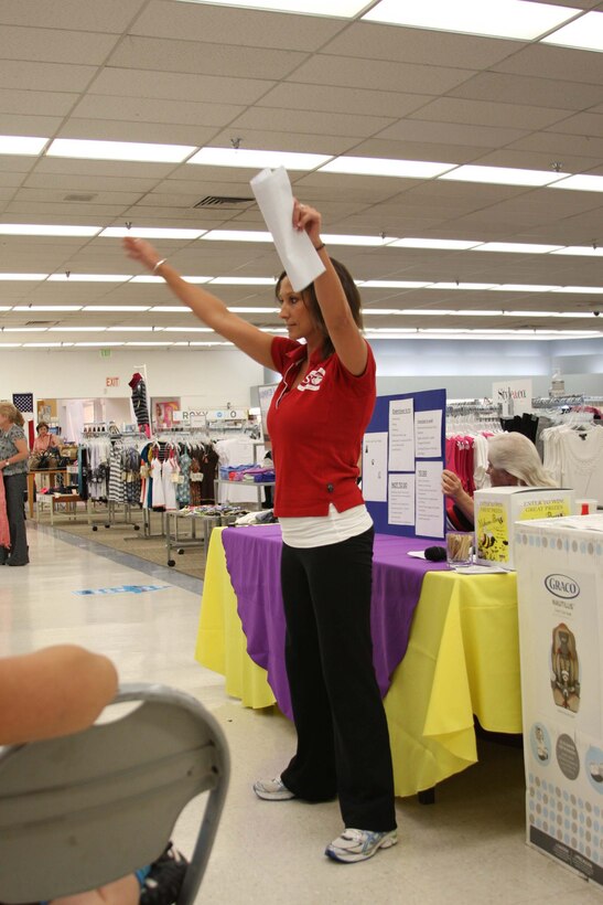 Melissa Dowd, a trainer at the East Gym and Fitness Center, presents workout options to mothers during and after pregnancy, and demonstrates some helpful and harmful workouts during the Mothers-to-Bee social at the Marine Corps Exchange June 15. ::r::::n::