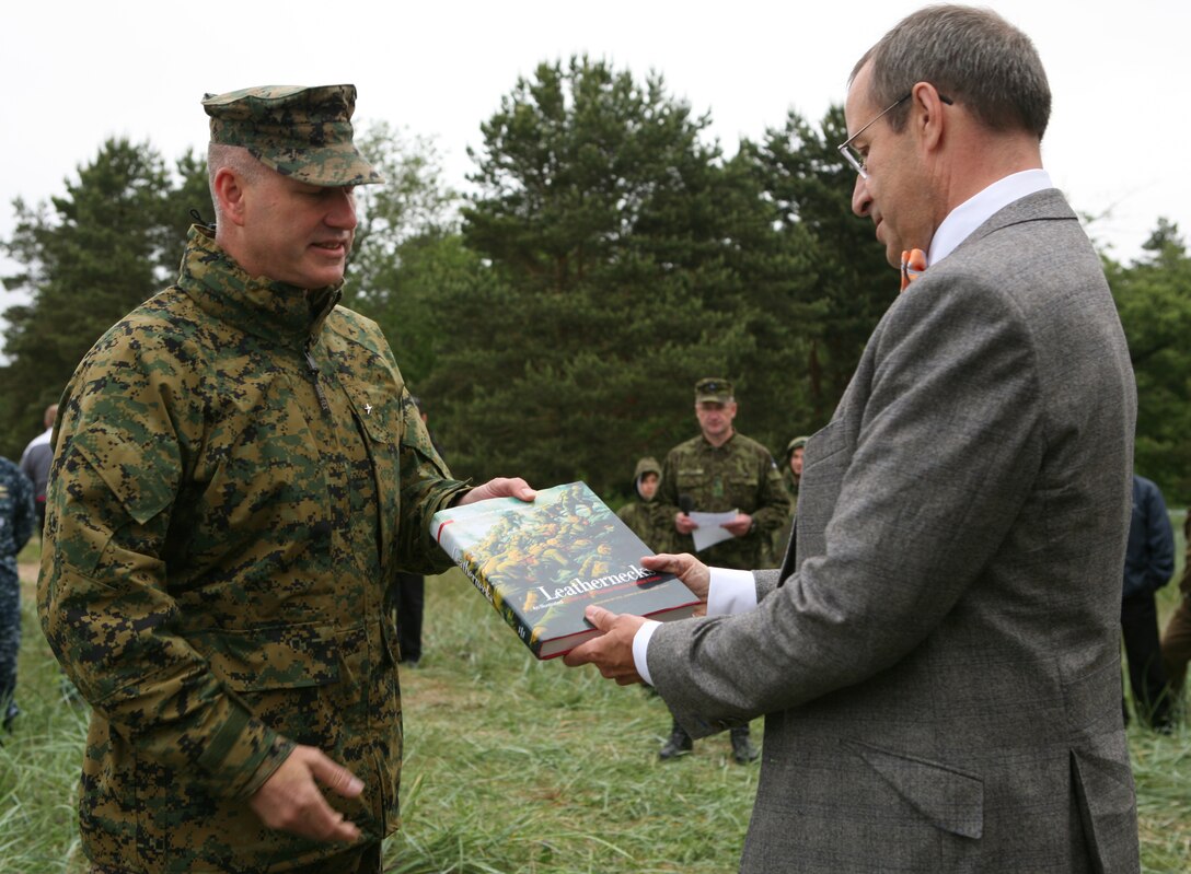 Estonian President Toomas Hendrik Ilves (left) receives a gift from Brig. Gen. Paul W. Brier, commander of Marine Forces Europe and Marine Forces Africa, prior to the demonstration of a combined U.S./Estonian amphibious assault. The amphibious landing was part of a demonstration of the interoperability between the two forces as part of exercise Baltic Operations 2010, an exercise designed to increase the interoperability of NATO and partner nations in the Baltic Sea region.