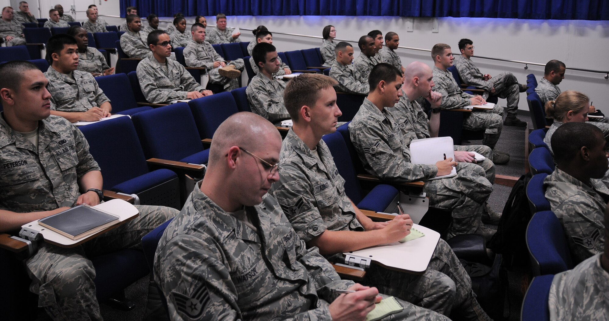 YOKOTA AIR BASE, Japan -- Airmen and their supervisors take notes on important information received at a Below the Zone seminar here June 15. Below the Zone is a program that allows airmen who qualify, to sew on Senior Airman six months prior to promotion. Below the Zone is statistically the second hardest stripe to earn in the Air Force since only 15 percent of all eligible airmen obtain the stripe six months early. (U.S. Air Force photo/Senior Airman Michael Dillon)