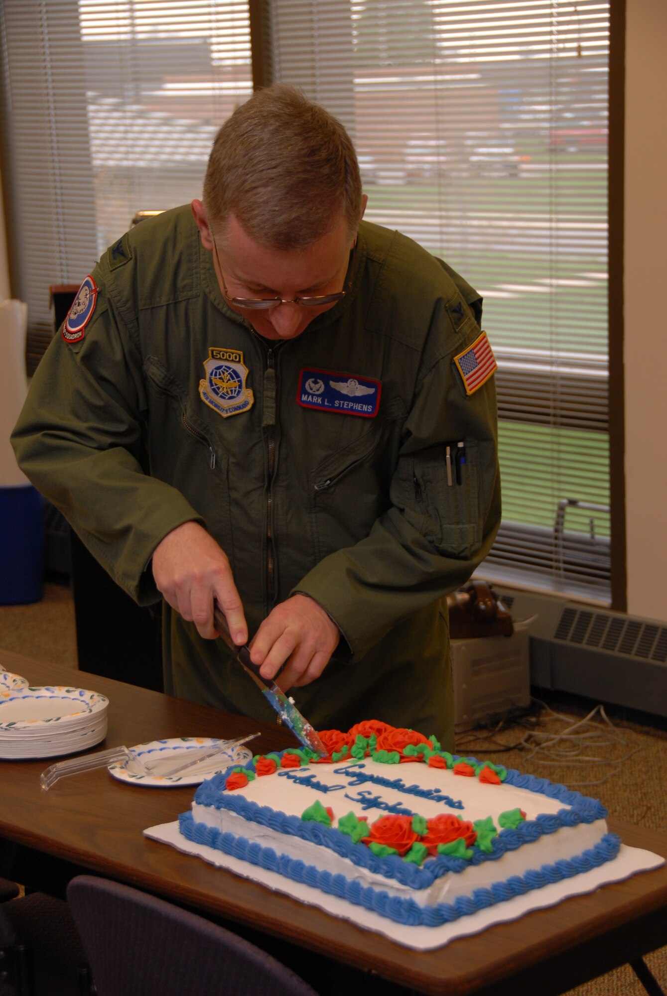 Colonel Mark L. Stephens cuts farewell cake prior to the Change of Command Ceremony on April 18, 2010,  at the 179th Airlift Wing, Mansfield, Ohio. Major General Harry "A.J." W. Feucht Jr. passed the role of Wing Commander onto Colonel Gregory N. Schnulo, releasing Col. Mark Stephens from his duty as the 179th Airlift Wing Commander.(U.S. Air Force photo by SRA Joseph Harwood) (RELEASED)