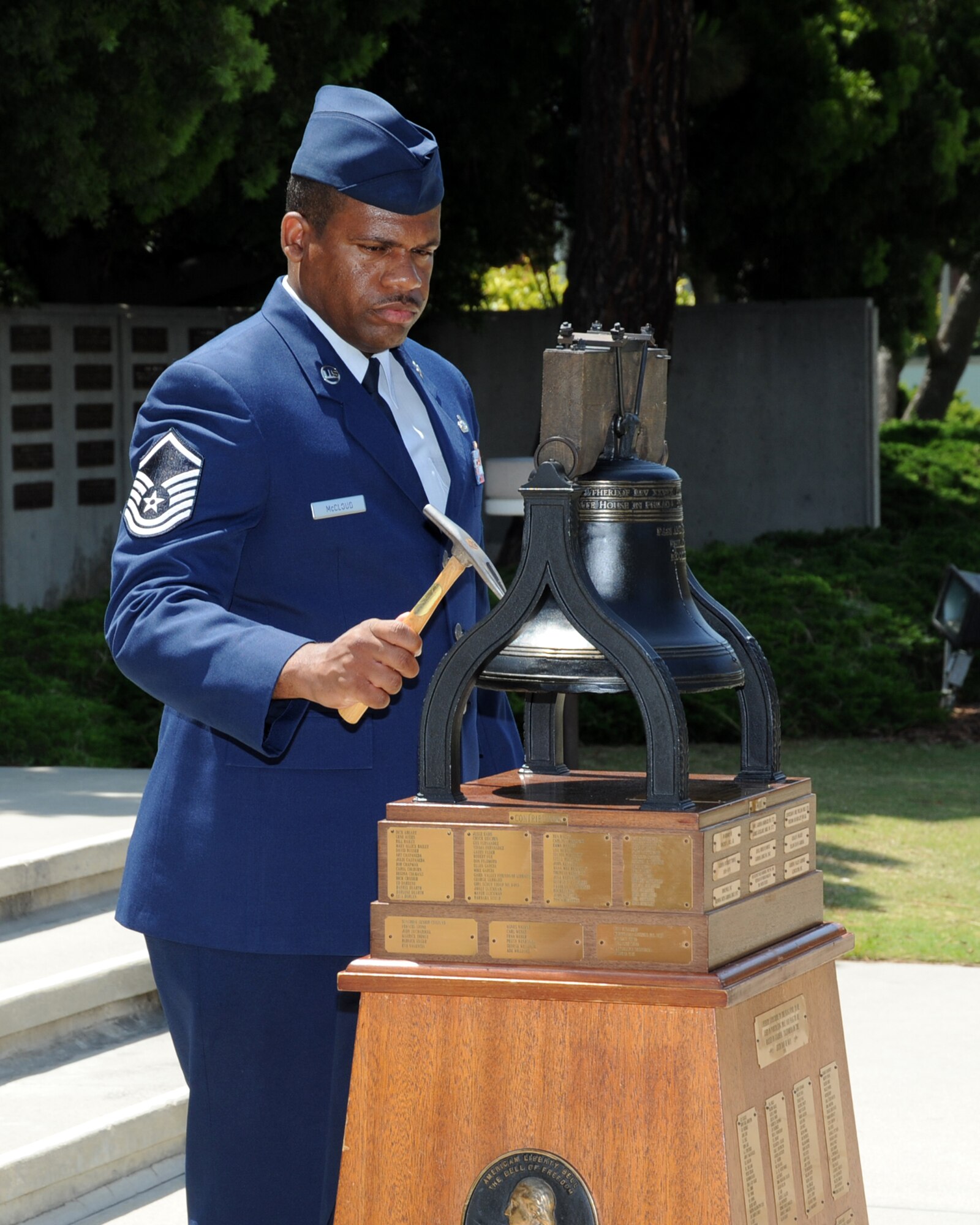 Master Sgt. David McCloud, 61st Air Base Wing, rings a bell at the City of Gardena's Flag Day Ceremony, June 14.  The master sergeant represented the Air Force at the ceremony, which commemorates the adoption of the U.S. flag in 1777. President Woodrow Wilson designated June 14 as Flag Day. (Photo by Lou Hernandez)