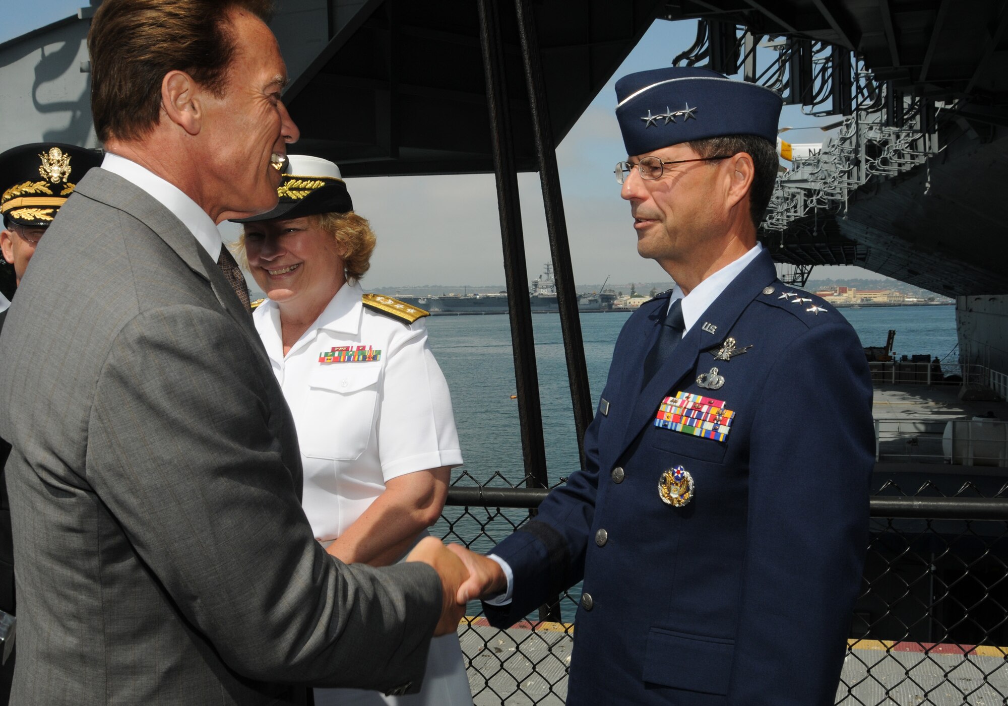 Lt. Gen. John “Tom” Sheridan, Space and Missile Systems Center commander, shakes hands with California Governor Arnold Schwarzenegger at the Operation Welcome Home kick-off, aboard the U.S.S. Midway in San Diego, June 3.   The first of its kind  in the nation, Operation Welcome Home is a statewide campaign to connect with returning veterans to determine their needs and connect them with the services that can help them transition successfully from the battle front to the home front.   (Photo by Joe Juarez)  