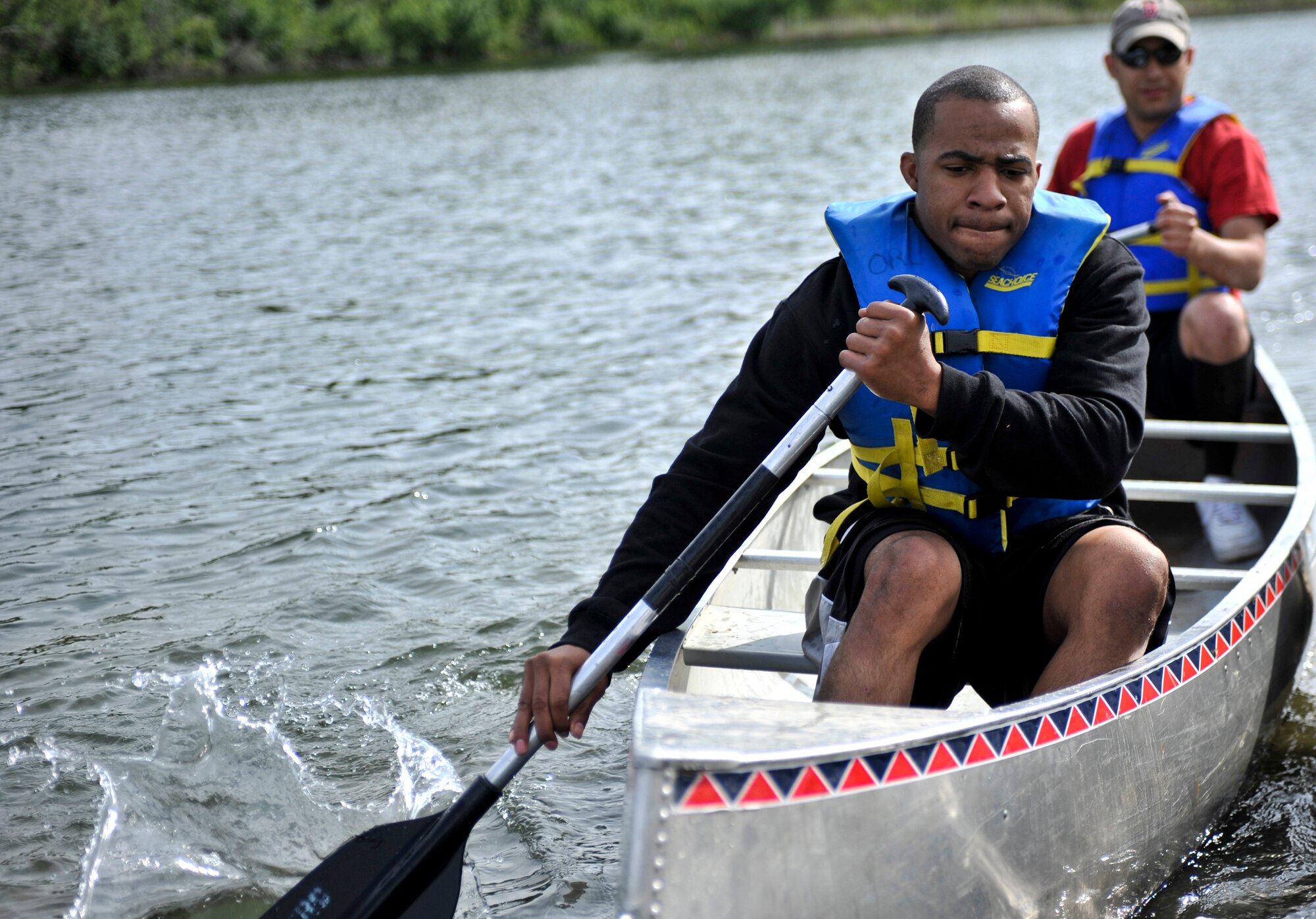 Competitors paddle their way back to land during a canoe race at Six-mile Lake for the annual Arctic Warrior Olympics, June 11. In conjunction with the games, the Anchorage Chamber of Commerce held their annual Military Appreciation Picnic for service members and their families stationed on the installation. (U.S. Air Force photo/Airman 1st Class Christopher Gross)
