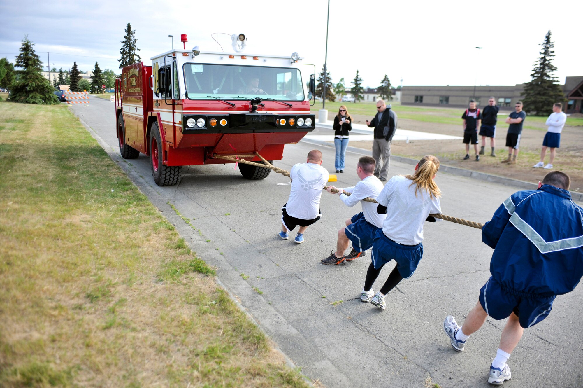Airmen pull a fire truck during the Arctic Warrior Olympics' truck pull, June 11. In conjunction with the games, the Anchorage Chamber of Commerce held their annual Military Appreciation Picnic for service members and their families stationed on the installation. (U.S. Air Force photo/Airman 1st Class Christopher Gross)