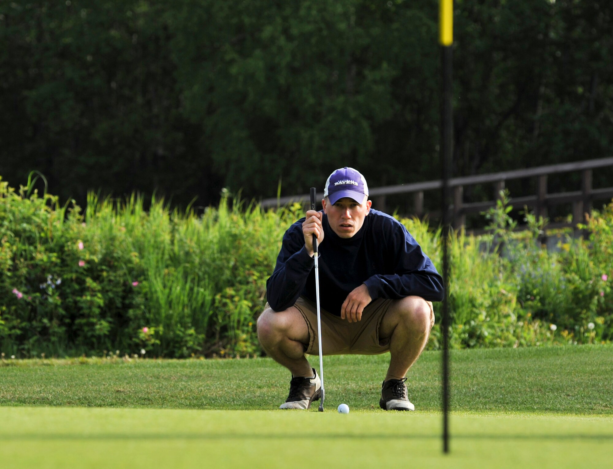 A golfer eyes a putt at the Eagleglen Golf Course during the Arctic Warrior Olympics, June 11.  In conjunction with the games, the Anchorage Chamber of Commerce held their annual Military Appreciation Picnic for service members and their families stationed on the installation. (U.S. Air Force photo/Airman 1st Class Christopher Gross)