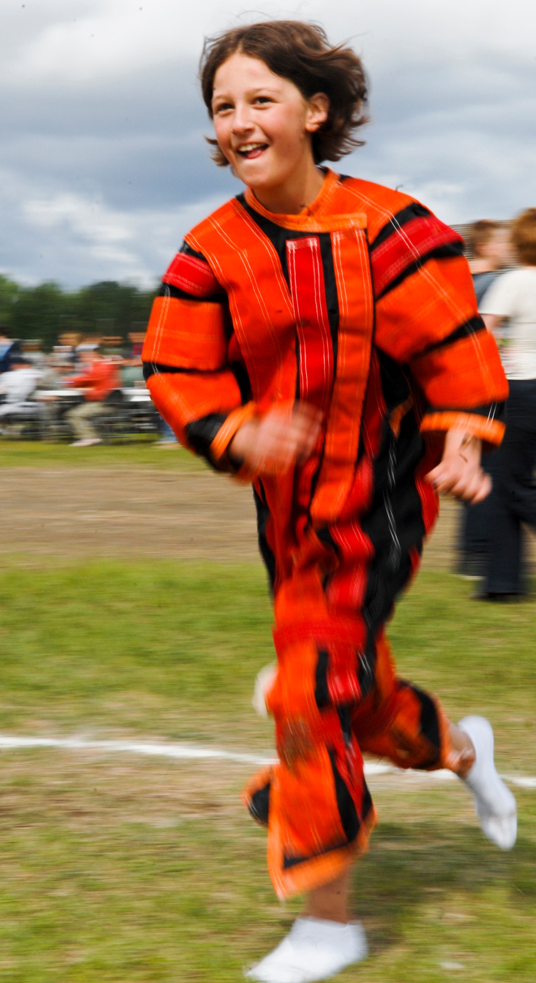 Mackenzie Huffman runs in a Velcro suit toward a Velcro wall at the Arctic Warrior Picnic, June 11. The picnic is an event held every June to bring members of Joint Base Elmendorf-Richardson together. (U.S. Air Force photo/Airman 1st Class Jack Sanders)