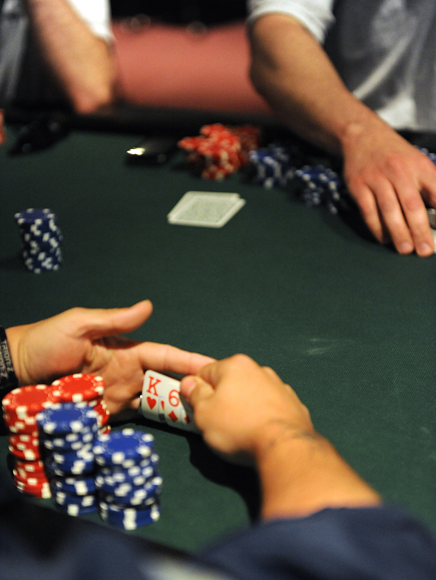 An Airman looks at his cards during a game of Texas Hold'em during the Arctic Warrior Olympics, June 11. The Arctic Warrior Olympics are held every June to bring the community on Joint Base Elmendorf-Richardson together. (Air Force photo by Senior Airman Cynthia Spalding)
