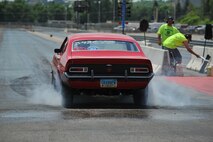 MINOT, N.D. – A participant at the Magic City International Dragway does a burnout before their race at the dragstrip here June 13. Street, modified and top ET cars, along with street or custom motorcycles and snowmobiles are encouraged to practice during test and tune runs and to race at the MCID. (U.S. Air Force photo by Master Sgt. Michael Gaddis)
