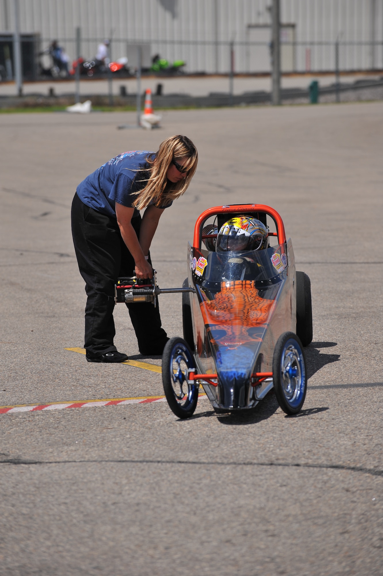 MINOT, N.D. – Local racer Julie Lander prepares her son’s junior dragster for a race at the Magic City International Dragway here June 13. Junior dragsters ages 8 to 16 are allowed to race at the dragway. These small but powerful vehicles can reach a maximum speed of 85 miles per hour under IHRA rules. The Lander family races three junior dragsters along with Julie’s car. (U.S. Air Force photo by Master Sgt. Michael Gaddis)