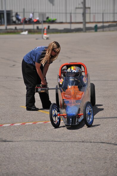 MINOT, N.D. – Local racer Julie Lander prepares her son’s junior dragster for a race at the Magic City International Dragway here June 13. Junior dragsters ages 8 to 16 are allowed to race at the dragway. These small but powerful vehicles can reach a maximum speed of 85 miles per hour under IHRA rules. The Lander family races three junior dragsters along with Julie’s car. (U.S. Air Force photo by Master Sgt. Michael Gaddis)