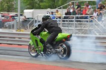 MINOT, N.D. -- A motorcycle leaves the burnout pit for the starting line during a race at the Magic City International Dragway here June 13. Street, modified and top ET (elapsed time) vehicles, street or custom motorcycles, and snowmobiles are encouraged to practice during test and tune runs and to race at the MCID. (U.S. Air Force photo by Master Sgt. Michael Gaddis)