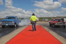 MINOT, N.D. -- Two vehicles start a burnout before their race at the Magic City International Dragway here June 13. Street, modified and top ET cars, along with street or custom motorcycles and snowmobiles are encouraged to practice during test and tune runs and to race at the MCID. (U.S. Air Force photo by Master Sgt. Michael Gaddis)