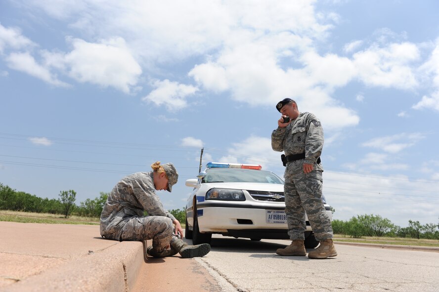 DYESS AIR FORCE BASE, Texas--Tech. Sgt. Joseph Dean, 7th Security forces Squadron, simulates the steps taken by a security forces member when pulling over a drunk driver June 15 here. There have been 12 off-base DUIs at Dyess in the first five months of 2010, while there were only 23 for the entire year last year. Drinking and driving isn’t the only alcohol-related incident that can have negative repercussions. Public intoxication, underage drinking, going to work drunk and having hangovers that prevent you from performing your duties are some of the serious incidents. (U.S. Air Force photo/ Airmen 1st Class Brittney Smolinski)