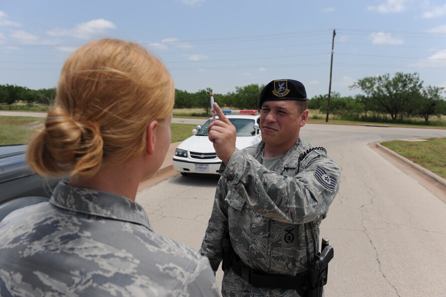 DYESS AIR FORCE BASE, Texas—Tech. Sgt. Joseph Dean, 7th Security forces Squadron, demonstrates a field sobriety test June 15 here. There have been 12 off-base DUIs at Dyess in the first five months of 2010, while there were only 23 for the entire year last year. Drinking and driving isn’t the only alcohol-related incident that can have negative repercussions. Public intoxication, underage drinking, going to work drunk and having hangovers that prevent you from performing your duties are some of the serious incidents. (U.S. Air Force photo/ Airmen 1st Class Brittney Smolinski)