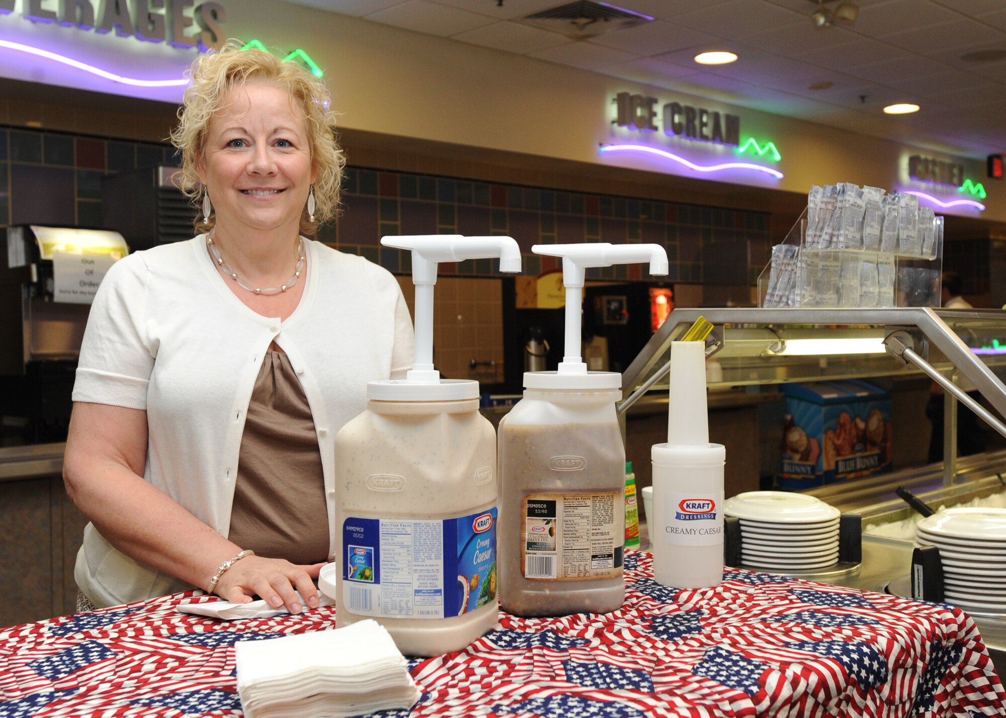 Julie Van Hoecke, Kraft Foods foodservice account manager, displays a stand with salad dressing for McConnell Airmen to try, June 9, 2010, McConnell Air Force Base, Kan.  The dining facility is host to several food vendors that offer free samples for Airmen and allow them to provide feedback.  The vendors visit every few months providing the dining facility the opportunity to provide a new selection of snacks, beverages and desserts that Airmen favor.  (U.S. Air Force photo/Airman 1st Class Andrea Salazar)