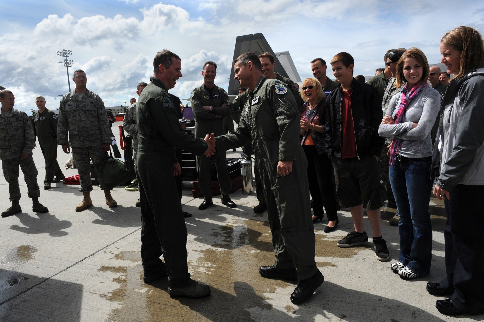 Brig. Gen. Thomas Bergeson shakes Col. William Routt's hand after returning from his fini-flight June 10. General Bergeson is the 3rd Wing commander and Colonel Routt is the 3rd Operations Group commander. (Air Force photo by Senior Airman Cynthia Spalding)
