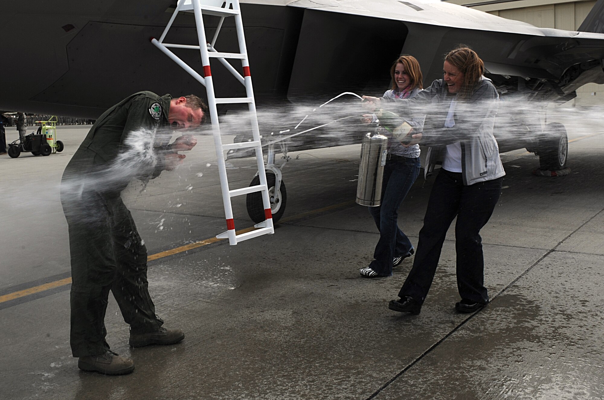 Brig. Gen. Thomas Bergeson, 3rd Wing commander, is greeted by his family with champagne and water after returning from his fini-flight June 10. (Air Force photo by Senior Airman Cynthia Spalding)