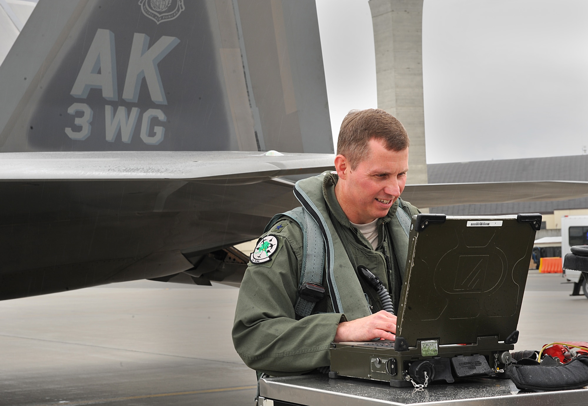 Brig. Gen. Thomas Bergeson, 3rd Wing commander, verifies the checklist on the portable maintenance aid before getting into the F-22 Raptor June 10 for his fini-flight. (Air Force photo by Senior Airman Cynthia Spalding)