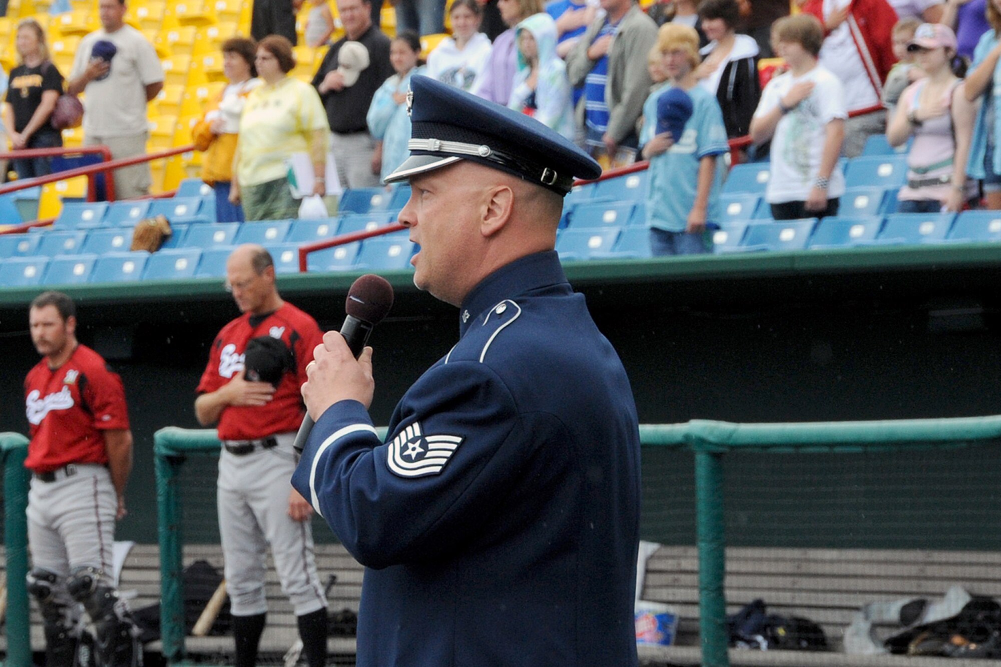 Offutt Air Force Base, Neb. --- Technical Sgt. Kenneth Maxwell, Heartland of America Band vocalist, performs the National Anthem before the start of the annual Military Appreciation Game June 13 at Rosenblatt Stadium. The Omaha Royals played the Nashville Sounds in front of a crowd of military members and their families. The Royals beat the Sounds  two to one to take the four game series three games to one. 