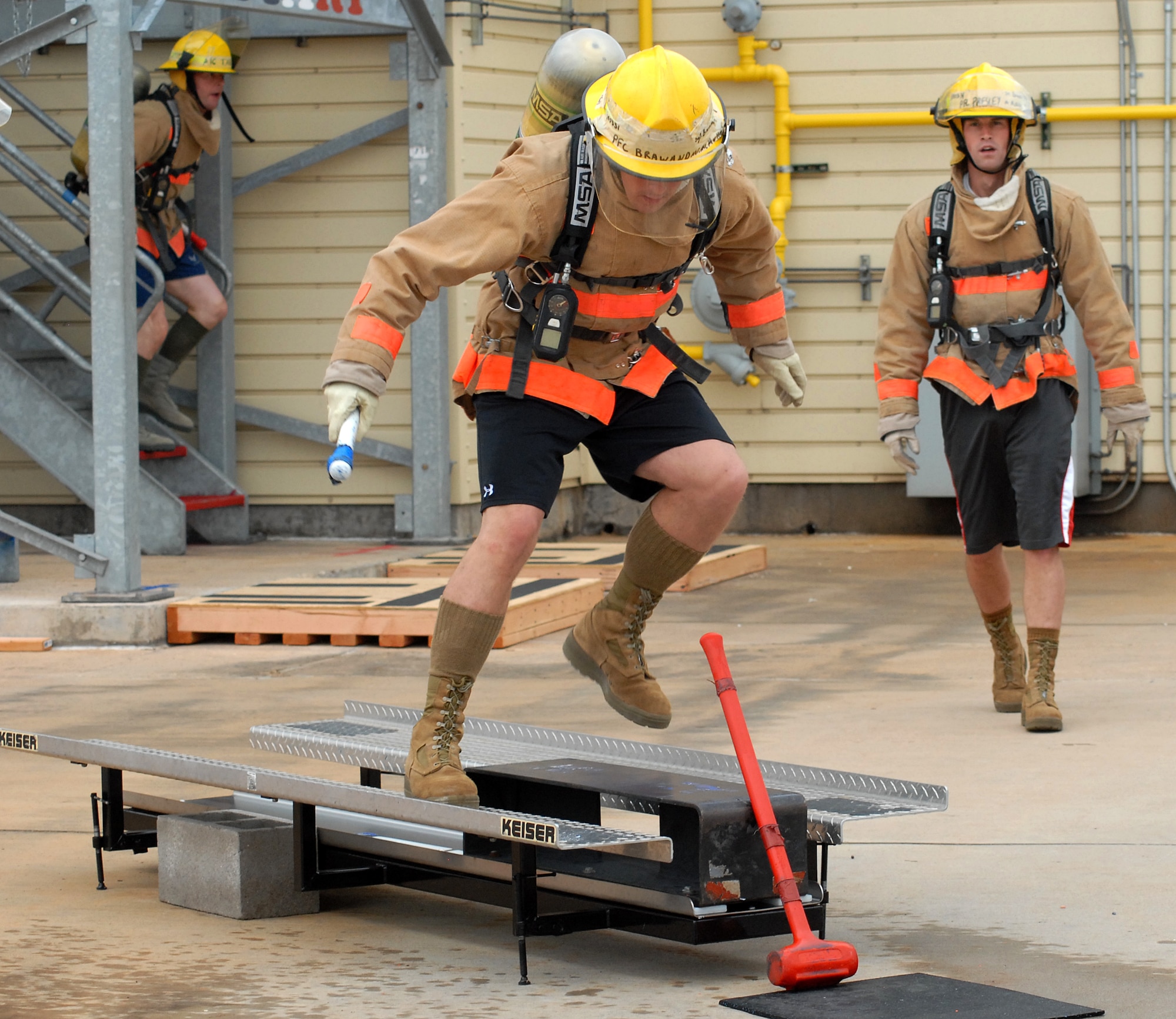 A competitor runs up to the third leg of the race where competitors must use a nine pound hammer to move a 150 pound block during the 2nd quarter Goodfellow AFB Rookie Firefighter Challenge June 12.  This is just one leg of a relay that is call the toughest two minutes in sports which pushes teams and individuals to their physical limits. (U.S. Air Force photo/Master Sgt Randy Mallard)