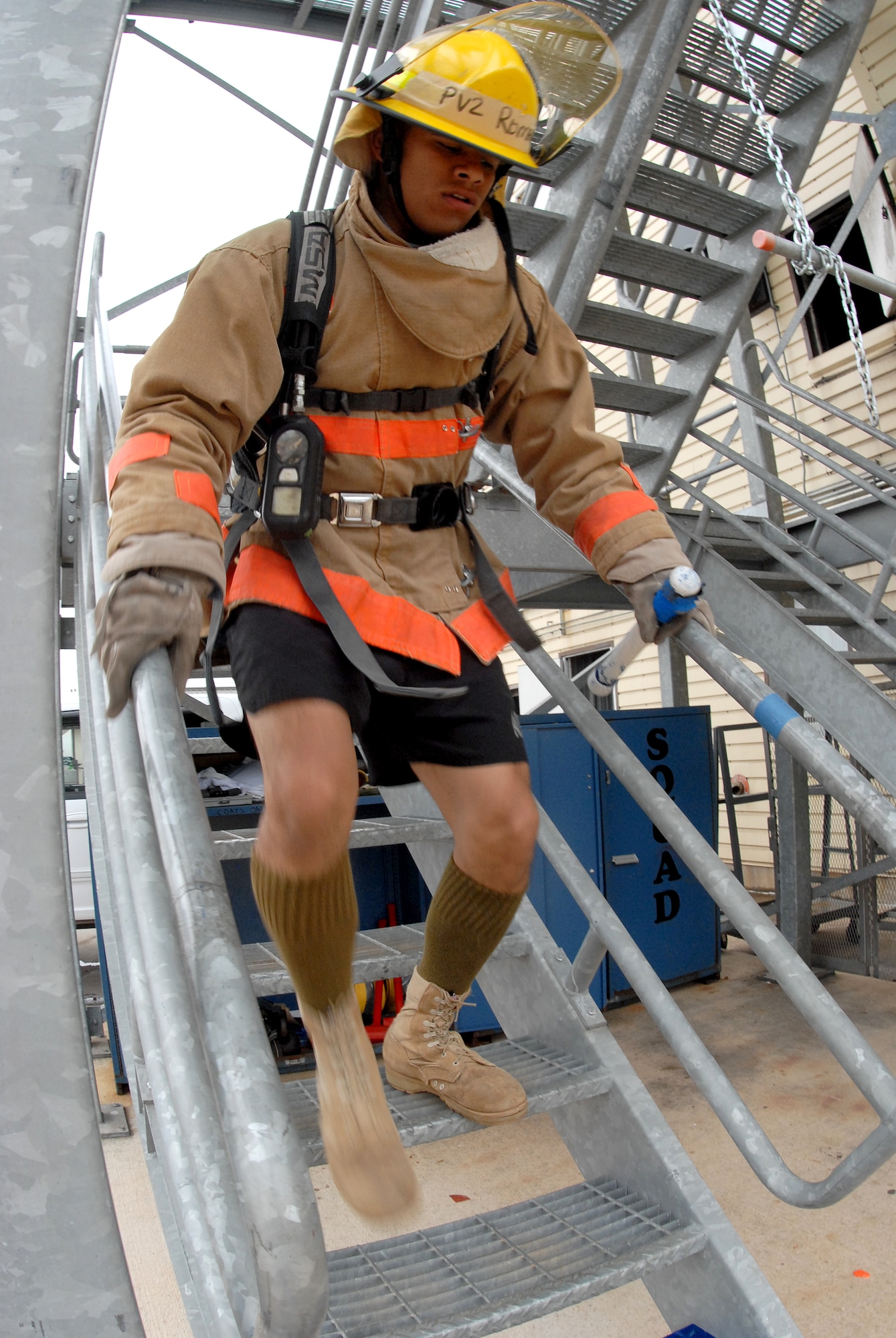 A competitor reaches the bottom stairs after descending five stories during the 2nd quarter Goodfellow AFB Rookie Firefighter Challenge June 12.  This is just one leg of a relay that is call the toughest two minutes in sports which pushes teams and individuals to their physical limits. (U.S. Air Force photo/Master Sgt Randy Mallard)