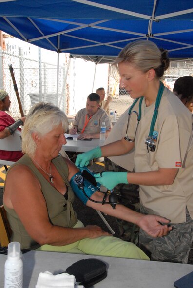 Senior Airman Elizabeth Goebel, an emergency medical technician with the 178th Medical Group, Springfield, Ohio, checks a patient's blood pressure June 7 at The Friendly Place, a homeless service center on the west of Kona, Hawaii.  The 178 MDG is on a medical training deployment in which it provides free medical services to underprivileged communities that do not have access to healthcare on the island..