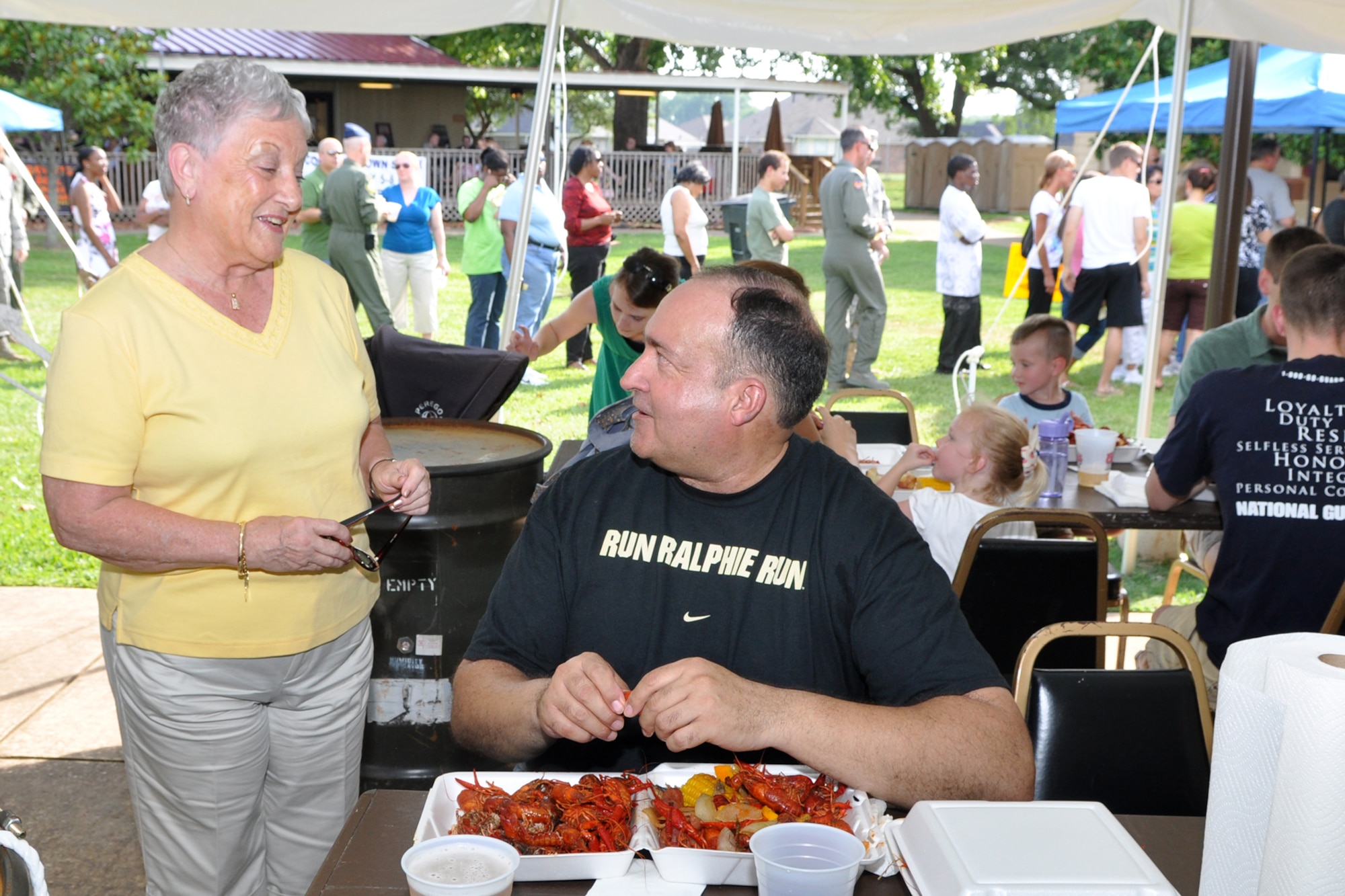 Ms. Helen Black and Lt. Col. Charlie Morgan, process manager, 917th Wing, enjoy a light conversation during the Barksdale Crawfish Festival at Barksdale Air Force Base, La., June 11, 2010.  Hundreds of people attended the “blow off some steam” event, which featured crawfish eating contests for the kiddies and adults, as well as live Zydeco music performed by the Red River Playboys from Shreveport, La. (U.S. Air Force photo/Tech. Sgt. Jeff Walston)