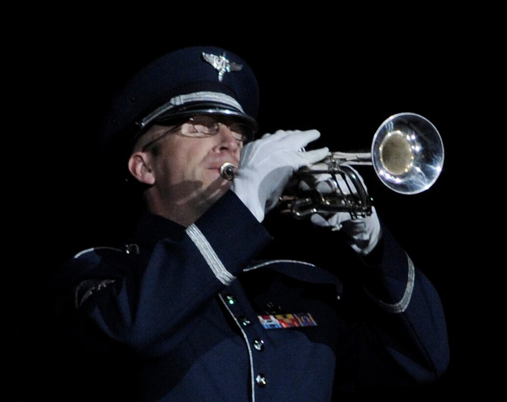 Master Sgt. Michael Bosch, United States Air Force Band, plays Taps during the Conference of American Air Chiefs Twilight Tattoo June 13 at the U.S. Air Force Ceremonial Lawn on Bolling Air Force Base. Gen. Norton A. Schwartz, U.S. Air Force chief of staff, hosted the event celebrating "50 Years of Friendship and Cooperation" between nations belonging to the System of Cooperation among American Air Forces. U.S. Air Force photo by Airman 1st Class Katherine Windish)